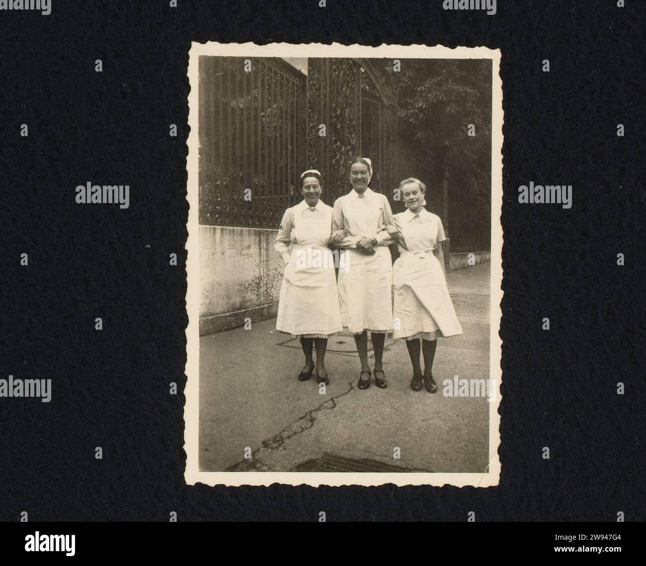 Three Nurses, 1943 photograph Three nurses in uniform, a fence on the left. In Paris at the beginning of May 1943. Part of the group of individual photos belonging to the photo album about the Kriegsmarine 1940-1943. Paris photographic support gelatin silver print nurse  hospital Paris Stock Photo