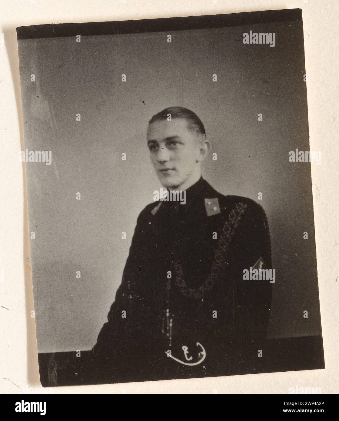 Portrait of a member of De Wa, 1940 - 1944 photograph Portrait of a member of the WA. On his collar a distinctive with two stars: companion, a low rank. On his right sleeve, the Wolfsangel (wa symbol) and a nest around his chest: adjutant. Barefoot. Netherlands photographic support  anonymous historical person portrayed Netherlands Stock Photo