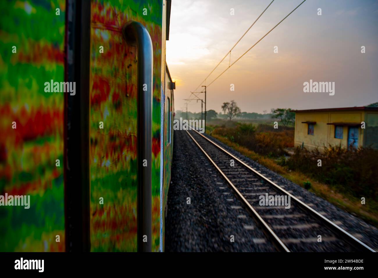 Railway lines and tracks and the door of a moving train. The handle of a Train door. Stock Photo