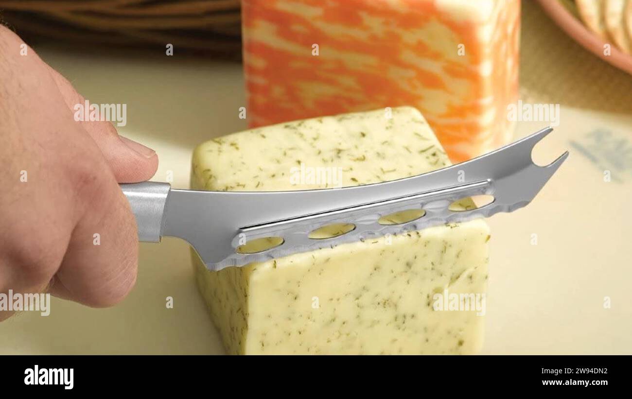 Cheese block-Whole cheese block transformed with finesse, as a skilled chef wields a cheese cutting knife. Each precise cut unveils culinary artistry. Stock Photo
