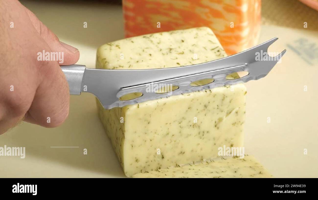Cheese block-Whole cheese block transformed with finesse, as a skilled chef wields a cheese cutting knife. Each precise cut unveils culinary artistry. Stock Photo