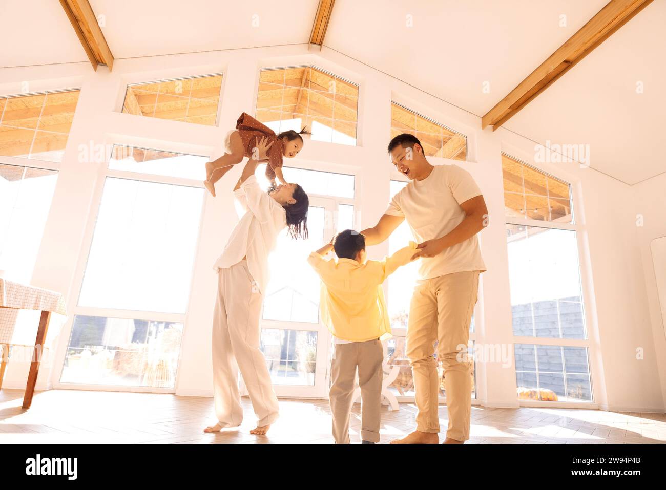 Happy Asian family is having fun at home. Korean young parents dancing ...
