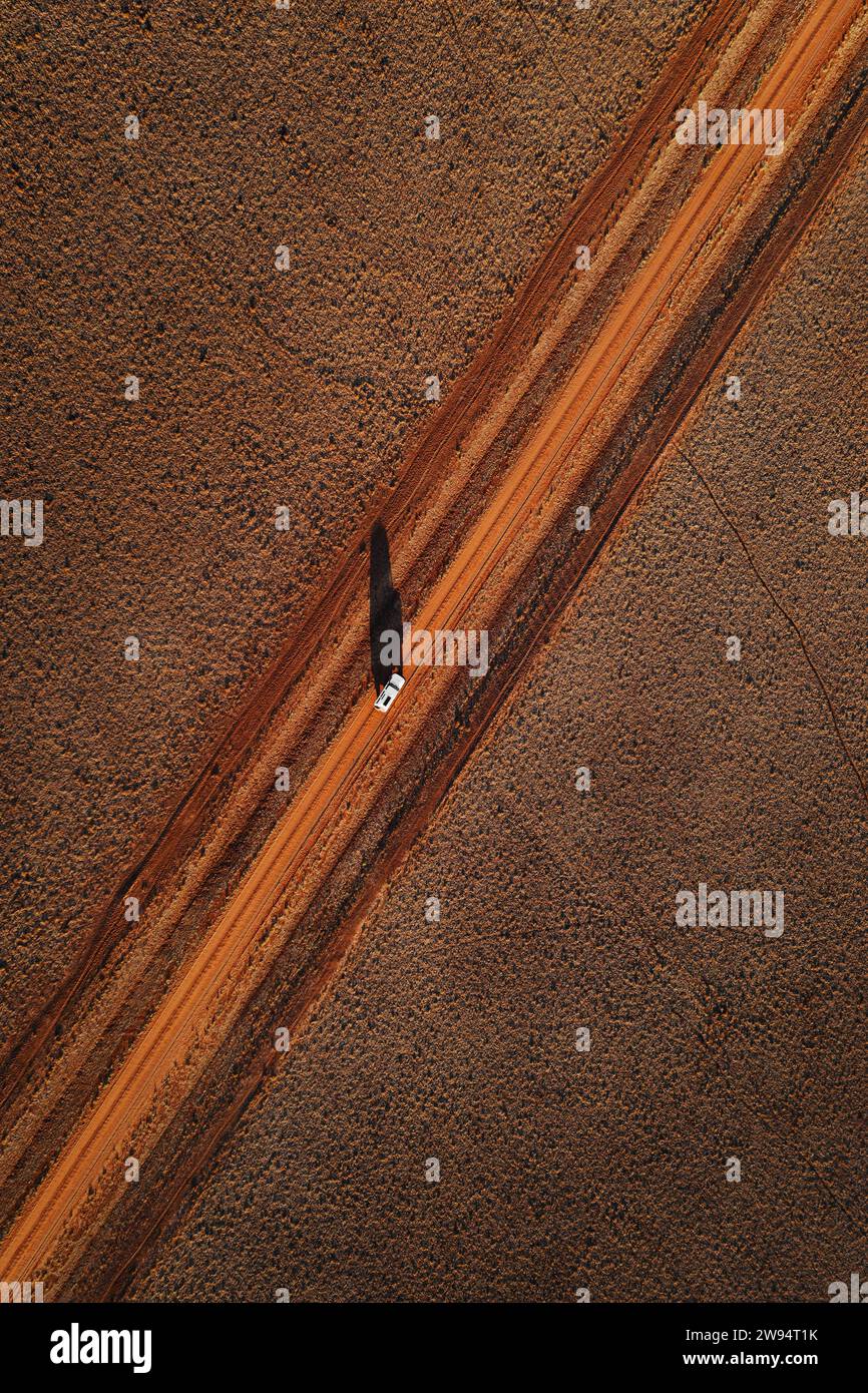 Aerial shot of a car on a remote outback dirt track. Stock Photo