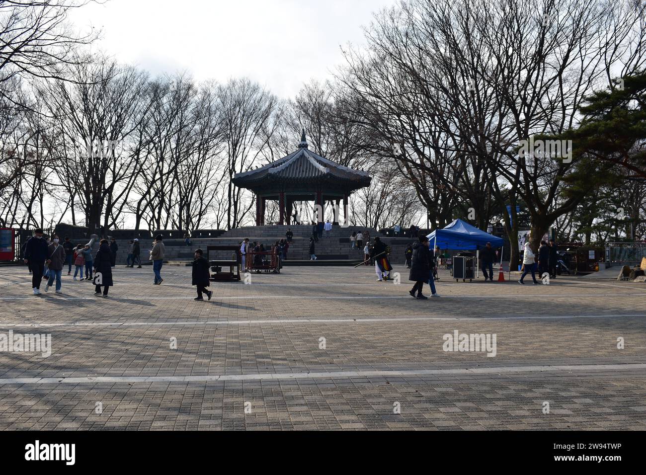 A view of people walking around Namsan Octagonal Square and the Palgakjeong Pavilion located on top of Namsan mountain Stock Photo