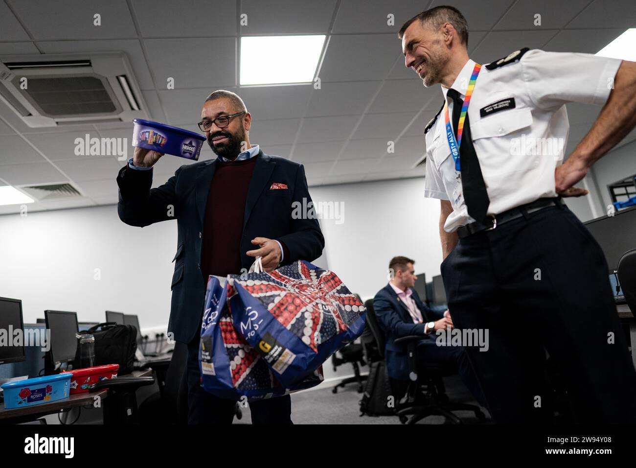 Home Secretary James Cleverly holds up a box of chocolates whilst meeting police officers at Luton Police Station to thank them for their service for working over the festive period. Picture date: Thursday December 21, 2023. Stock Photo