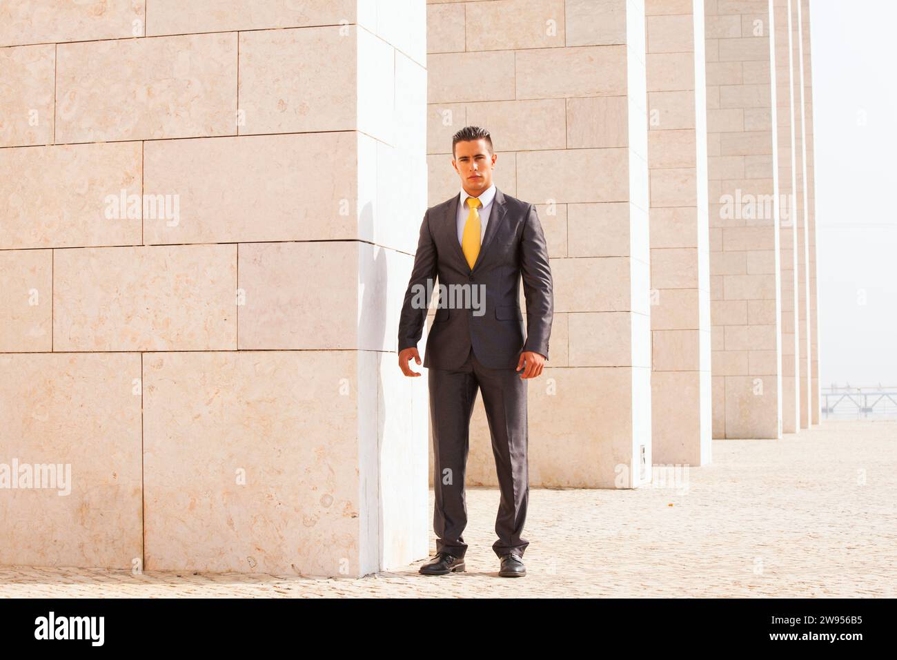 Sad businessman next to some wall looking down Stock Photo