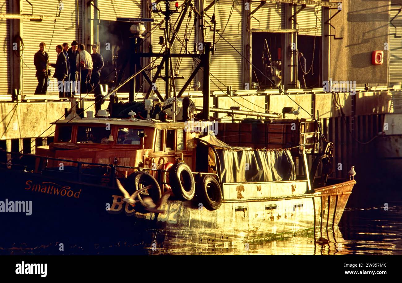 Aberdeen Harbour and fish market fishermen and a fishing vessel in the