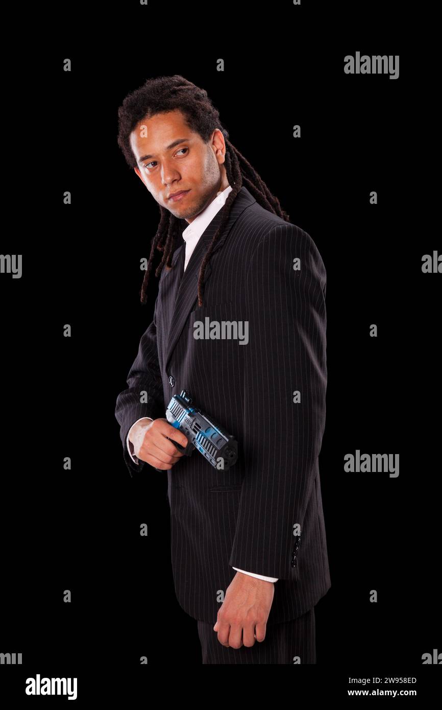 Powerful young man with a gun Stock Photo - Alamy