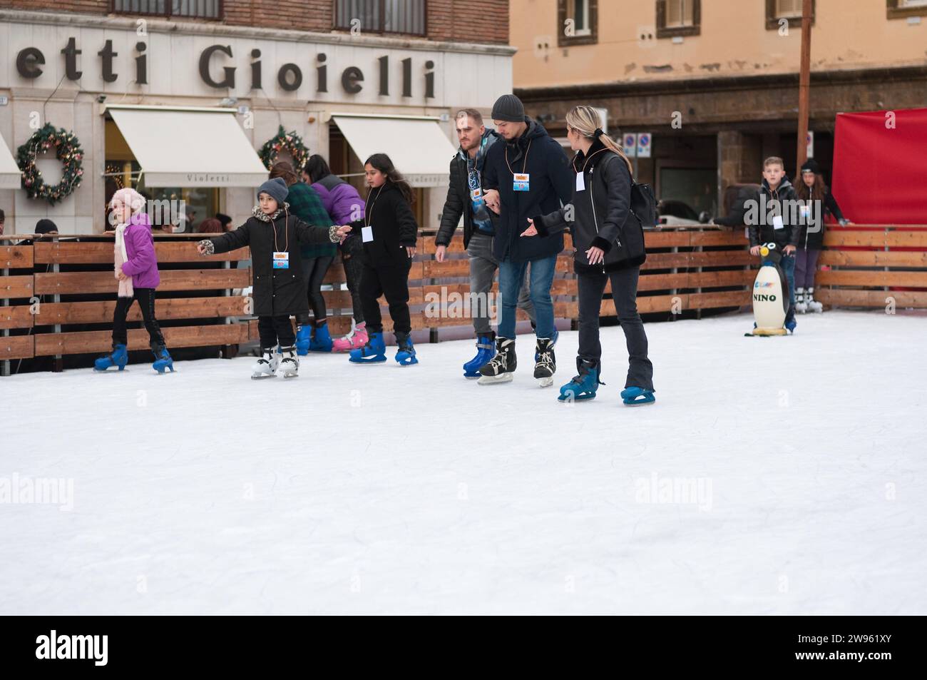People skating on ice during Christmas holidays, shallow DOF. Stock Photo