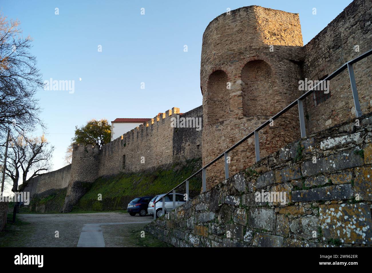 Bastions and ramparts of the Castle of Abrantes, western side with the gate tower and ramp, view in sunset light, Portugal Stock Photo