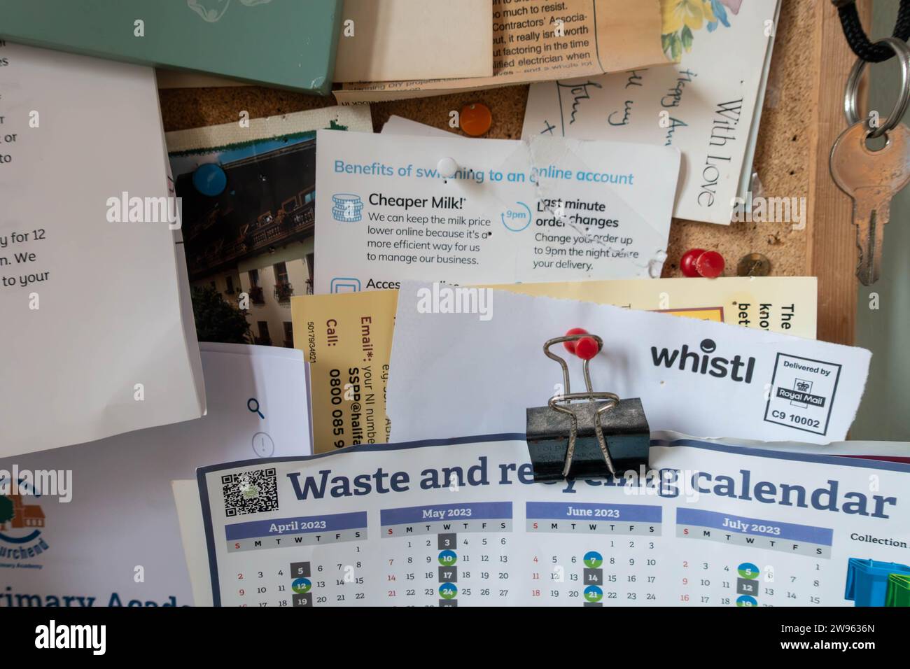 A cork notice board with letters, information and notices pinned in