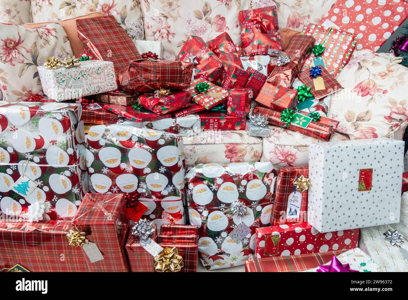 Christmas presents on a settee, wrapped in decorative festive wrapping