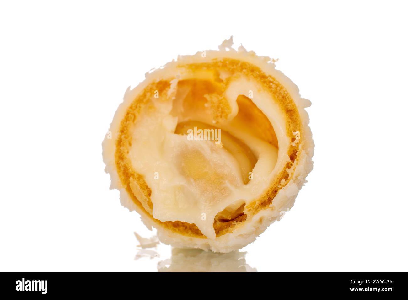 One half candy with nut and coconut flakes, macro, isolated on white