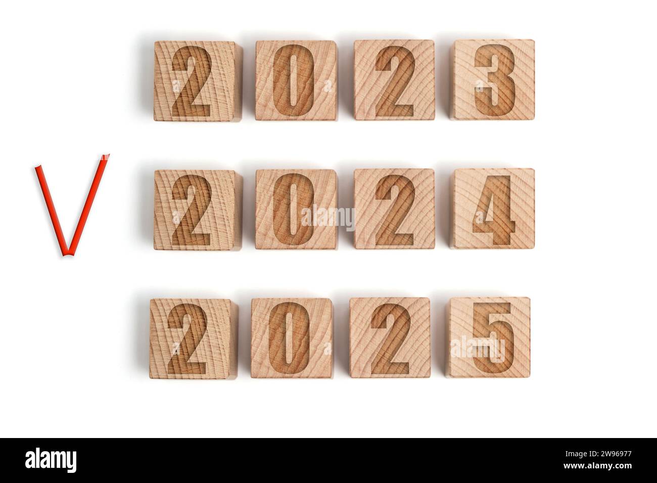 Wooden cubes with years 2023,2024 marked with red check mark and 2025 Stock Photo