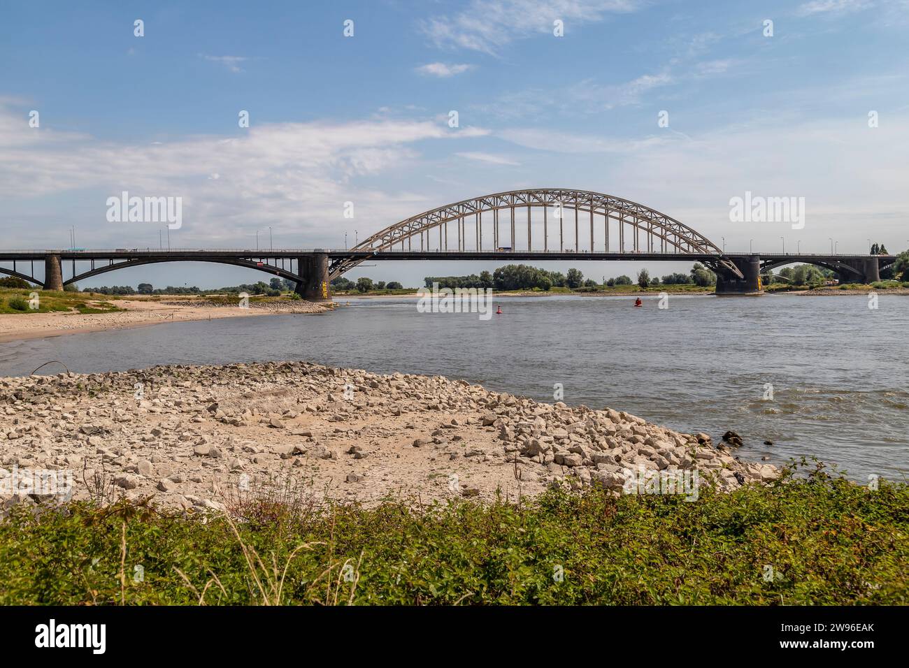 Very low water level in the river Waal at the Waal bridge (Waalbrug) in Nijmegen. Stock Photo
