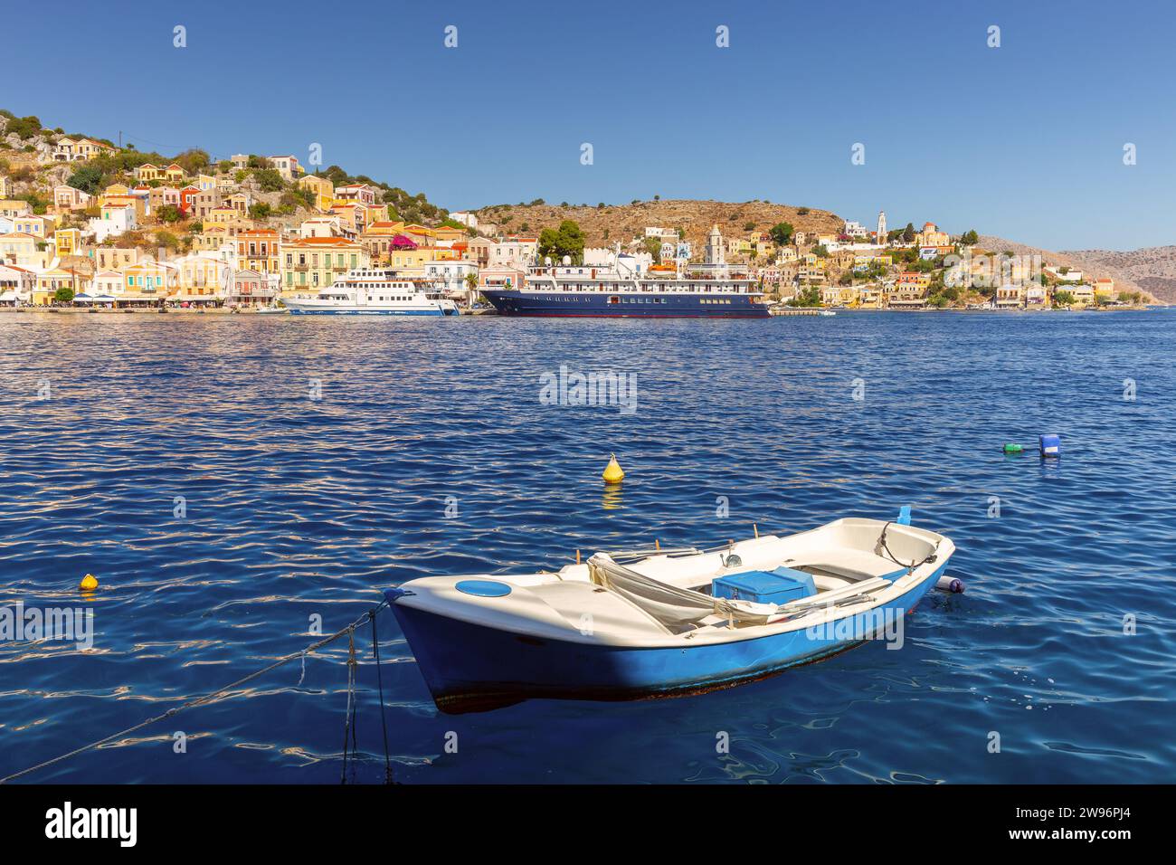 View of old traditional fishing boats in the harbor of Sumi village on a sunny day. Greece. Dodecanese. Stock Photo