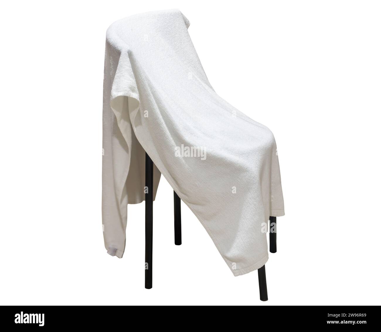 Used white towel laying on chair is isolated on white background with clipping path. Stock Photo