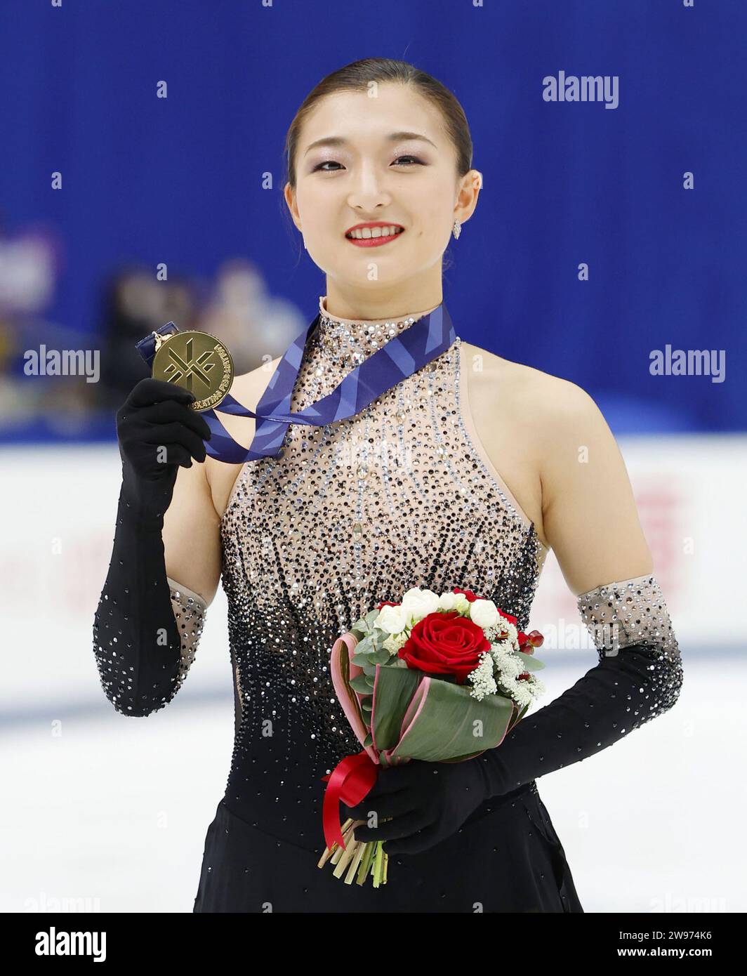Kaori Sakamoto poses after winning the gold medal in the women's event