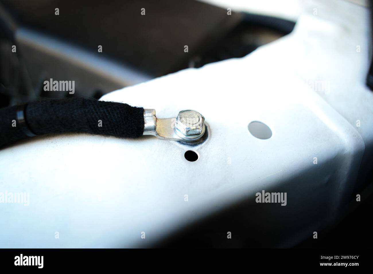 Ground wire or negative electrode on car chassis in engine compartment