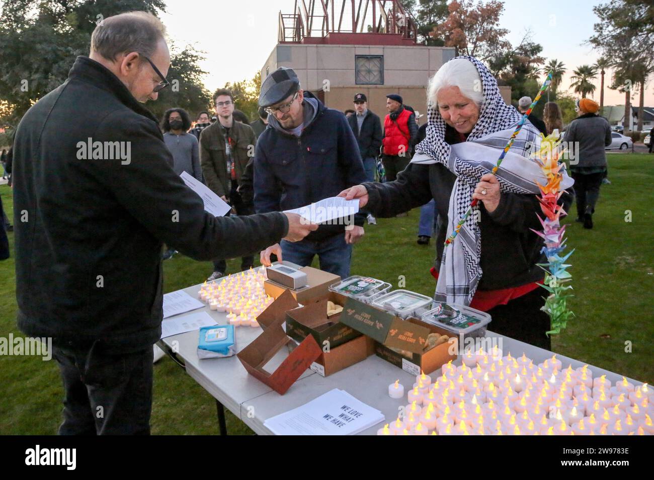 People get candles and song sheets at the start of the peaceful
