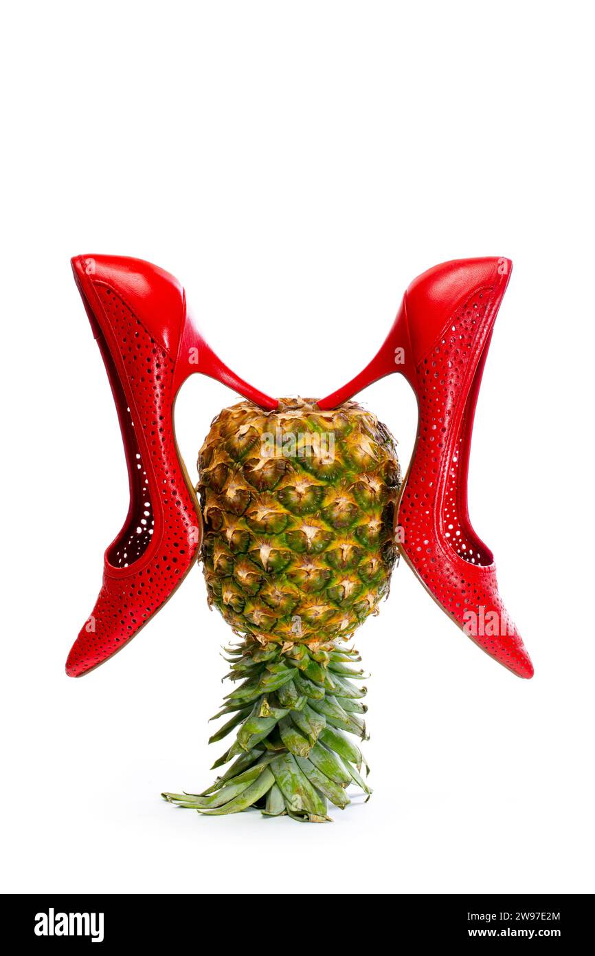 Women's red high-heeled shoes with pineapple on a white background Stock Photo