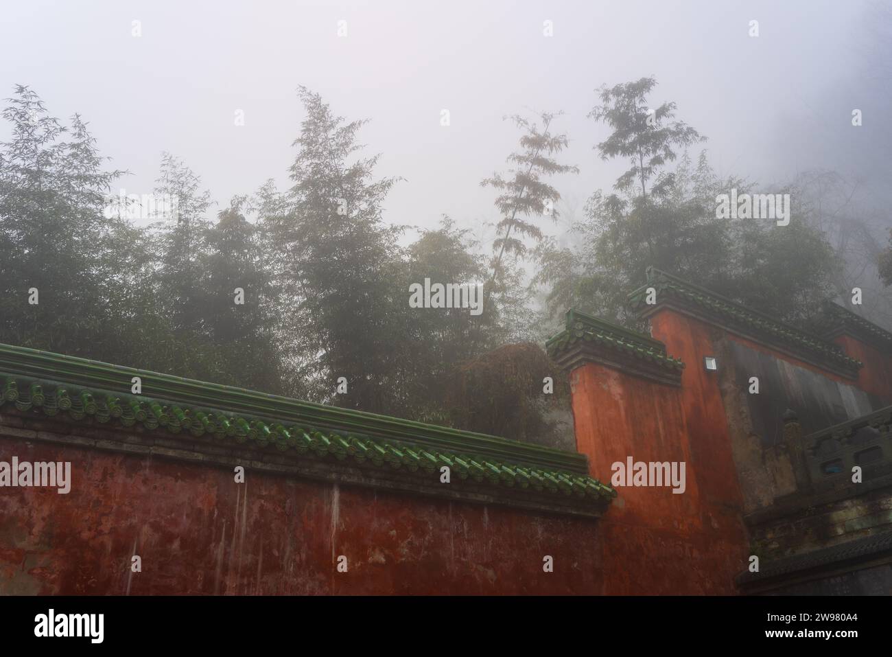 Wudang Mountain appears serene and mysterious shrouded in mist, emphasizing the ancient architecture and natural beauty of the mountain, China. Stock Photo