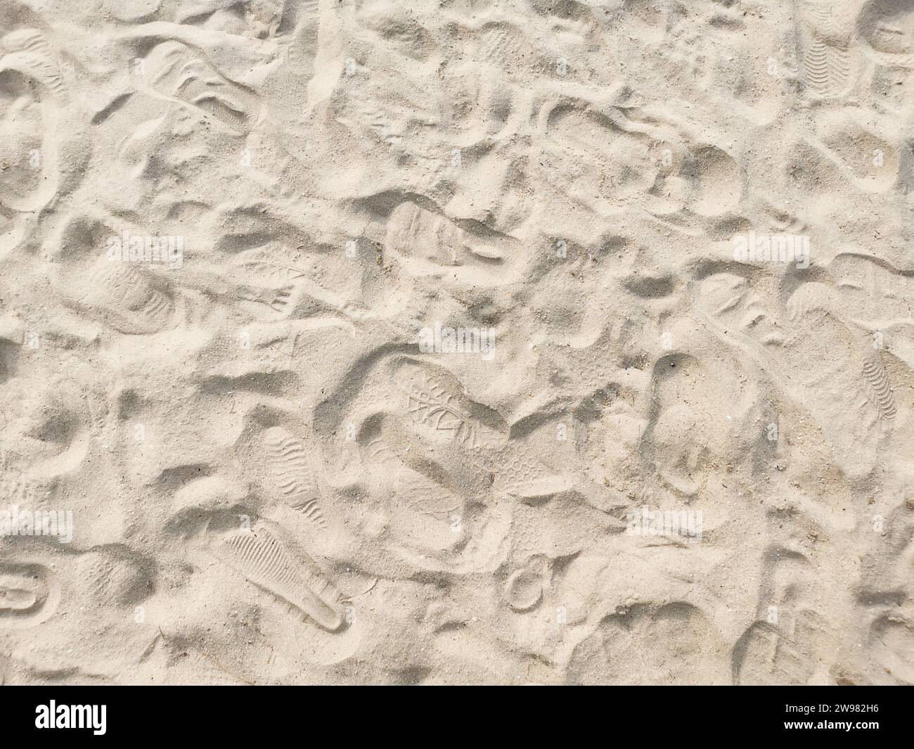 Dry sand creating an abstract textured background with shadows and light Stock Photo