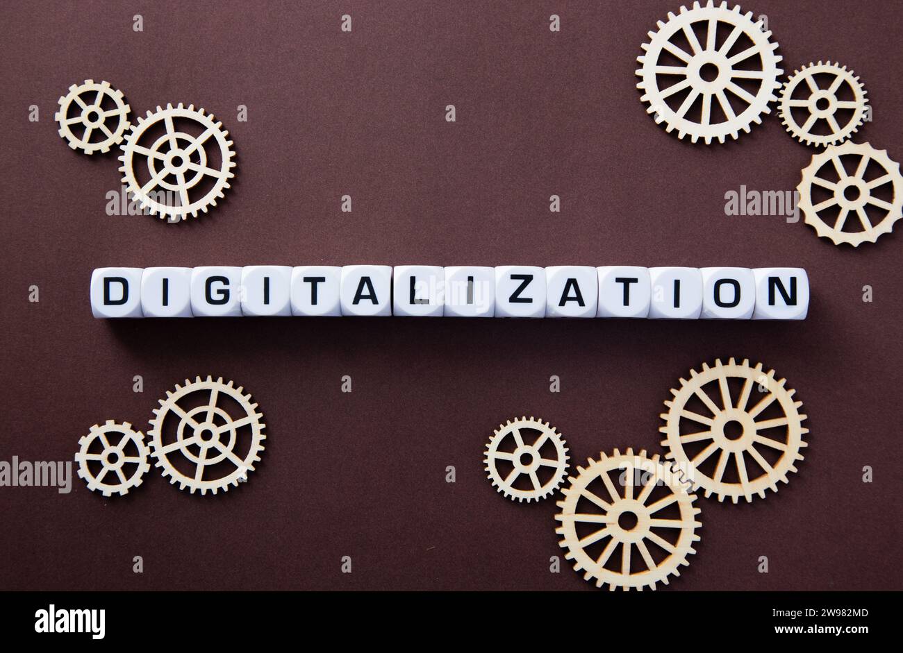 Wooden gears with word Digitalization. Stock Photo