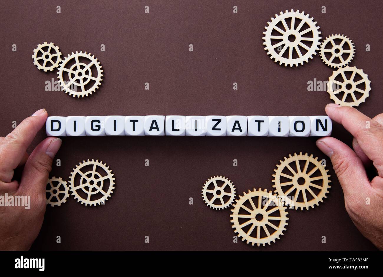 Wooden gears with word Digitalization. Stock Photo