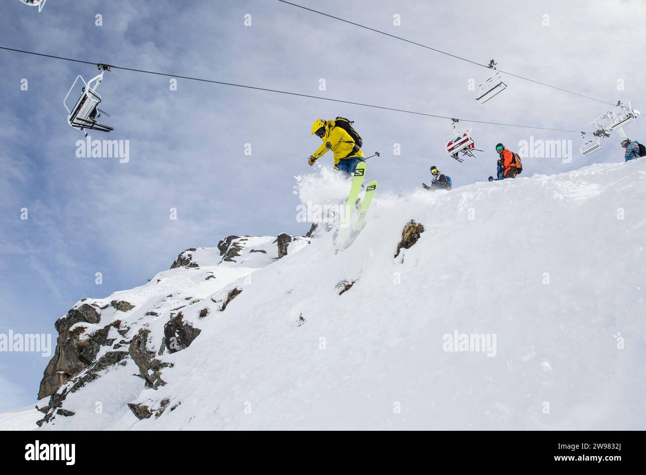 Pro rider giving a workshop on freeride competition skiing and choosing you line wisely. Here he is simply jumping into the subject. Stock Photo