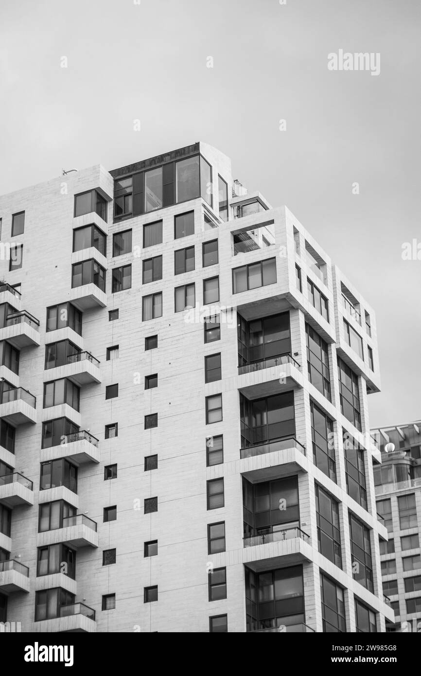 A grayscale shot of a multi-story apartment complex in Tel Aviv, Israel Stock Photo