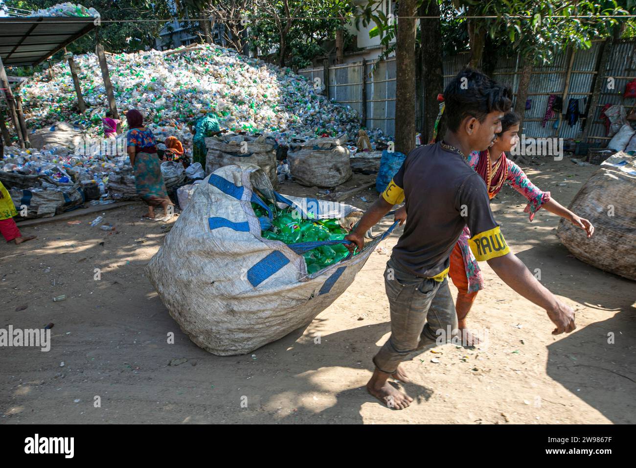 Workers sort used plastic bottles at a recycling factory. Recycle of