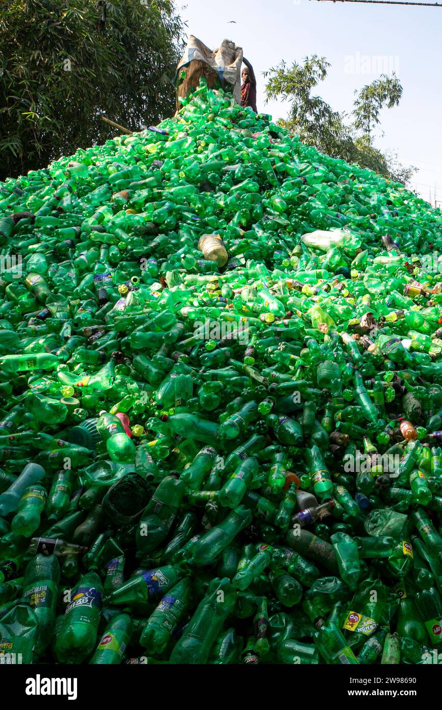 Workers sort used plastic bottles at a recycling factory. Recycle of