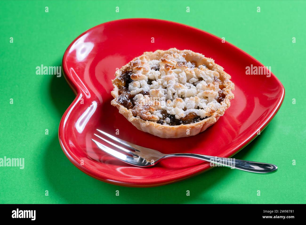 A traditional handmade mince pie and topped with flakes of marzipan ...