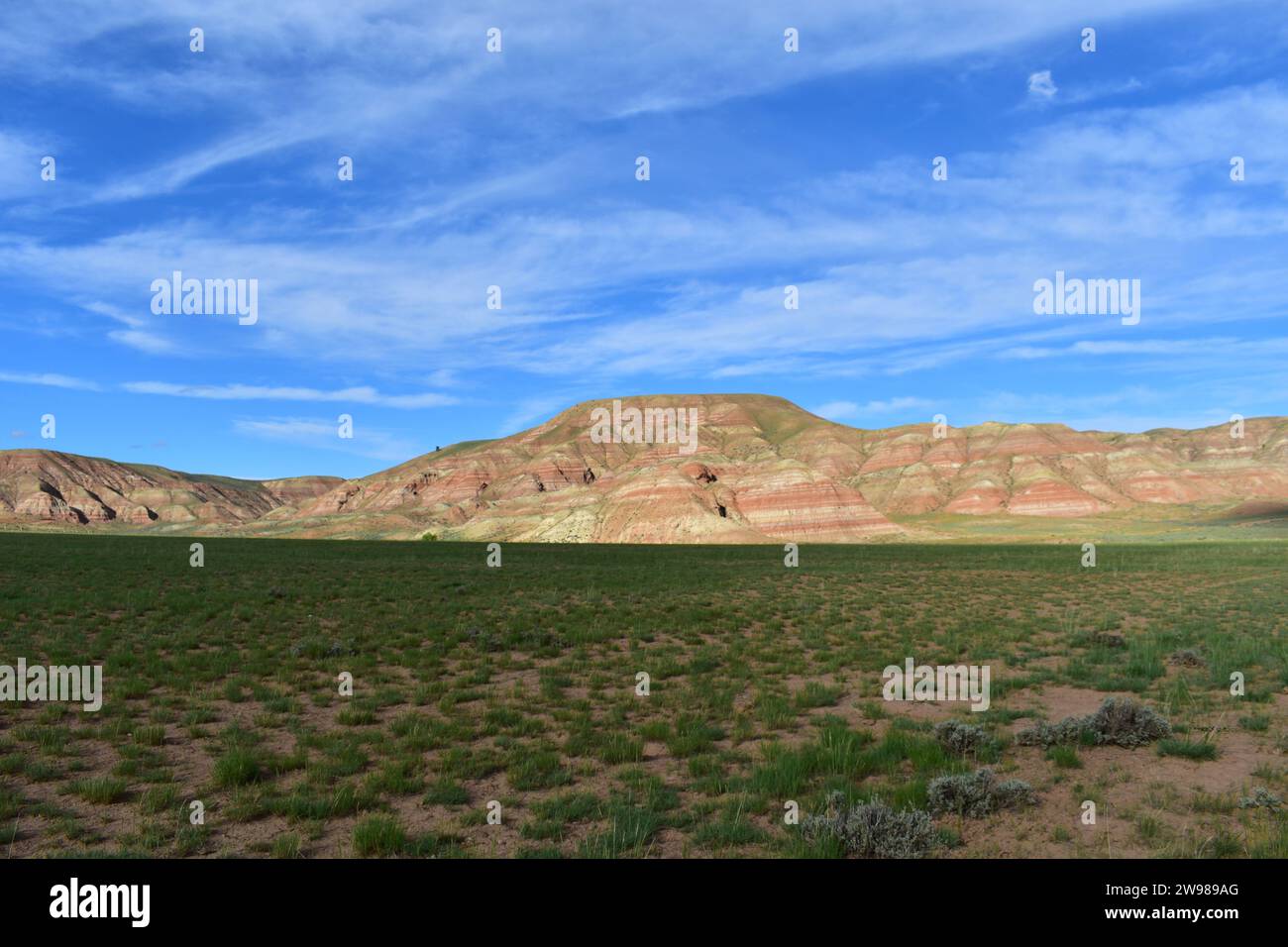 View of the colorful sedimentary sandstone mountains in the west of the Wind River Indian Reservation next to Highway 26 in Wyoming Stock Photo