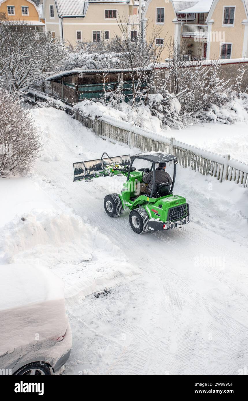 snow removal with a small tractor in Malmkoping, Sweden Stock Photo - Alamy