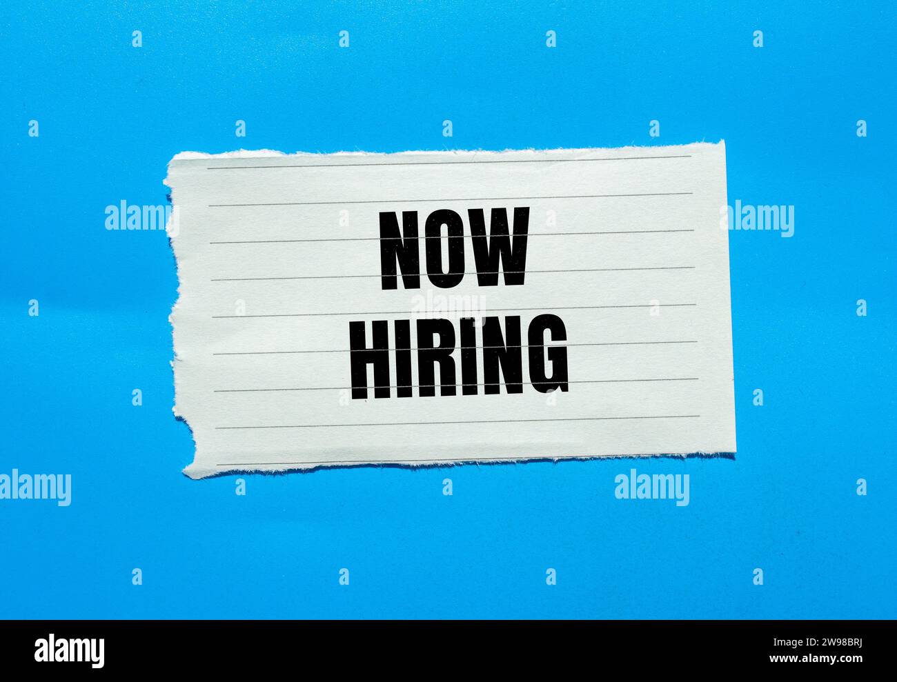 Now hiring lettering on ripped paper. Business recruitment concept