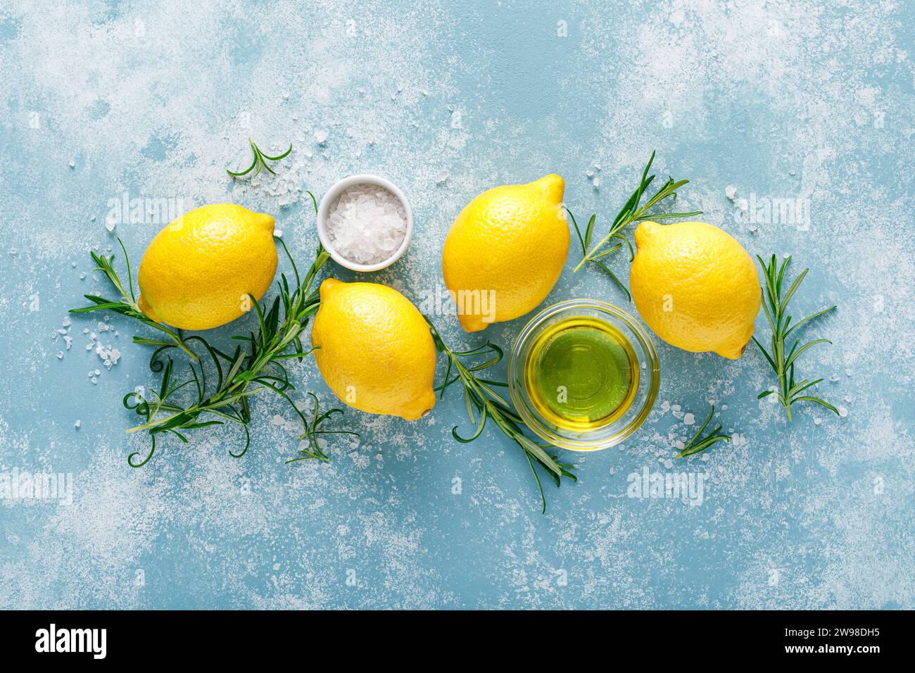 Lemon, rosemary, garlic, salt and olive oil. Ingredients for mediterranean cuisine cooking. Top view Stock Photo
