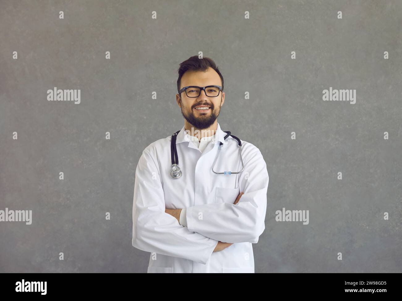 Happy young doctor crossed arms hi-res stock photography and images - Alamy