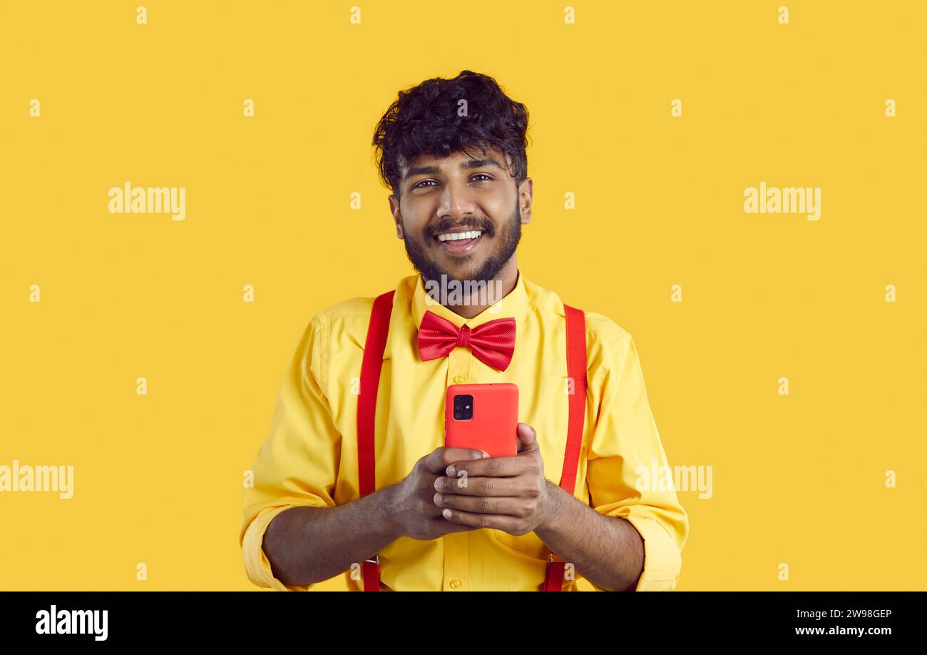 Smiling Indian man use modern cellphone texting Stock Photo