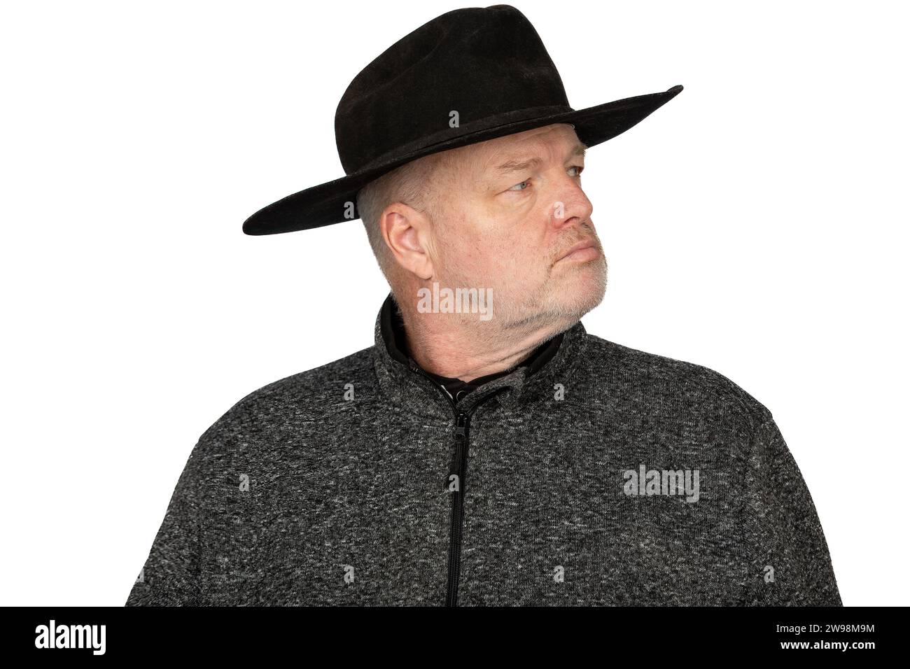 Serious Middle-Aged Caucasian Man in Worn Cowboy Hat looking to the Side - Isolated Portrait on White Background Stock Photo
