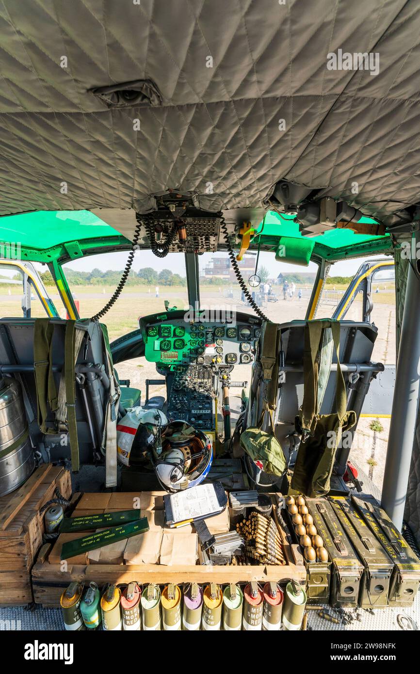 Interior, 1960's US decommission Bell Huey UH1 Iroquois Helicopter. Pilot and co-pilot's seat with flight controls. Ammo in front. Used in Vietnam. Stock Photo