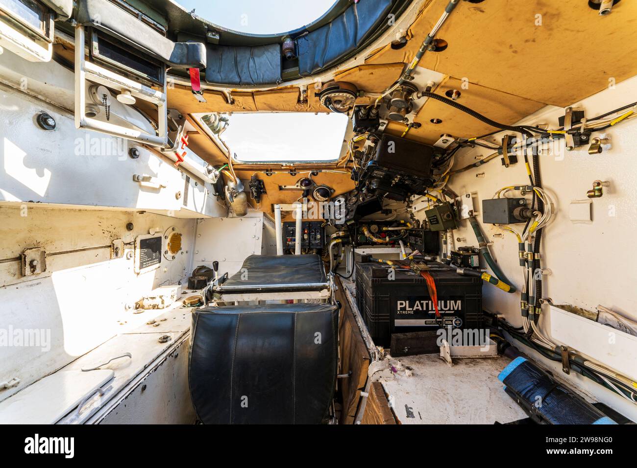 Interior of a decommissioned F432 armoured personal carrier. Looking forward to the drivers seat, vehicle control and large side battery. Stock Photo