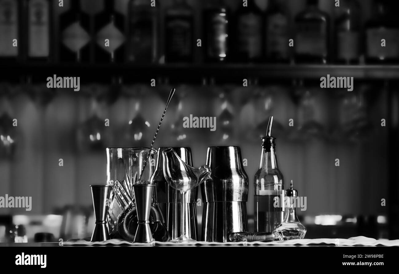 Set of bar accessories for making cocktails, located on the bar, behind
