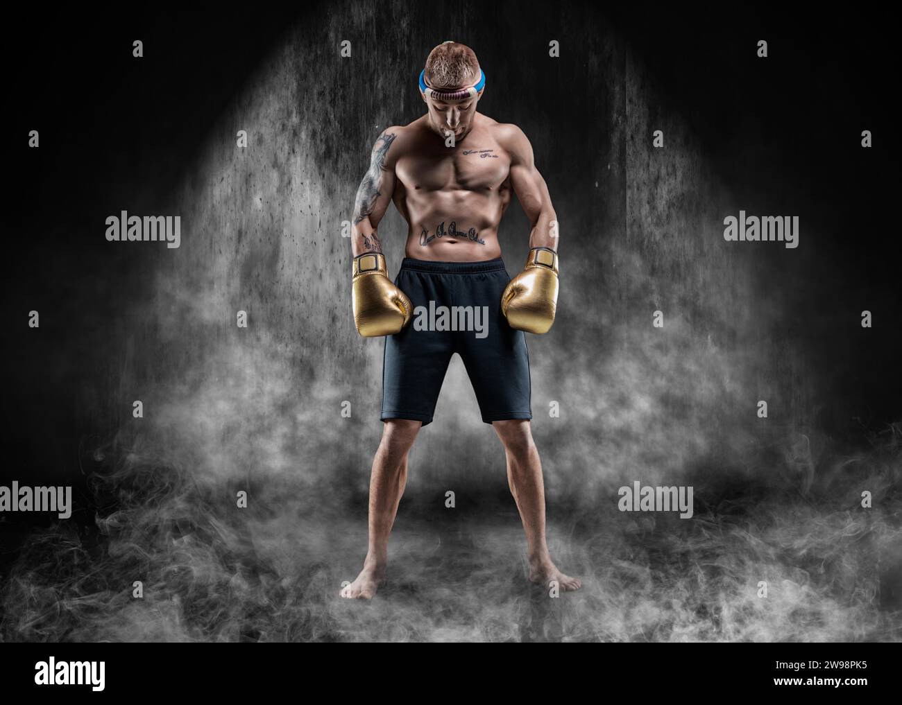 Professional wrestler is standing in the smoke in a dark place. Mixed ...
