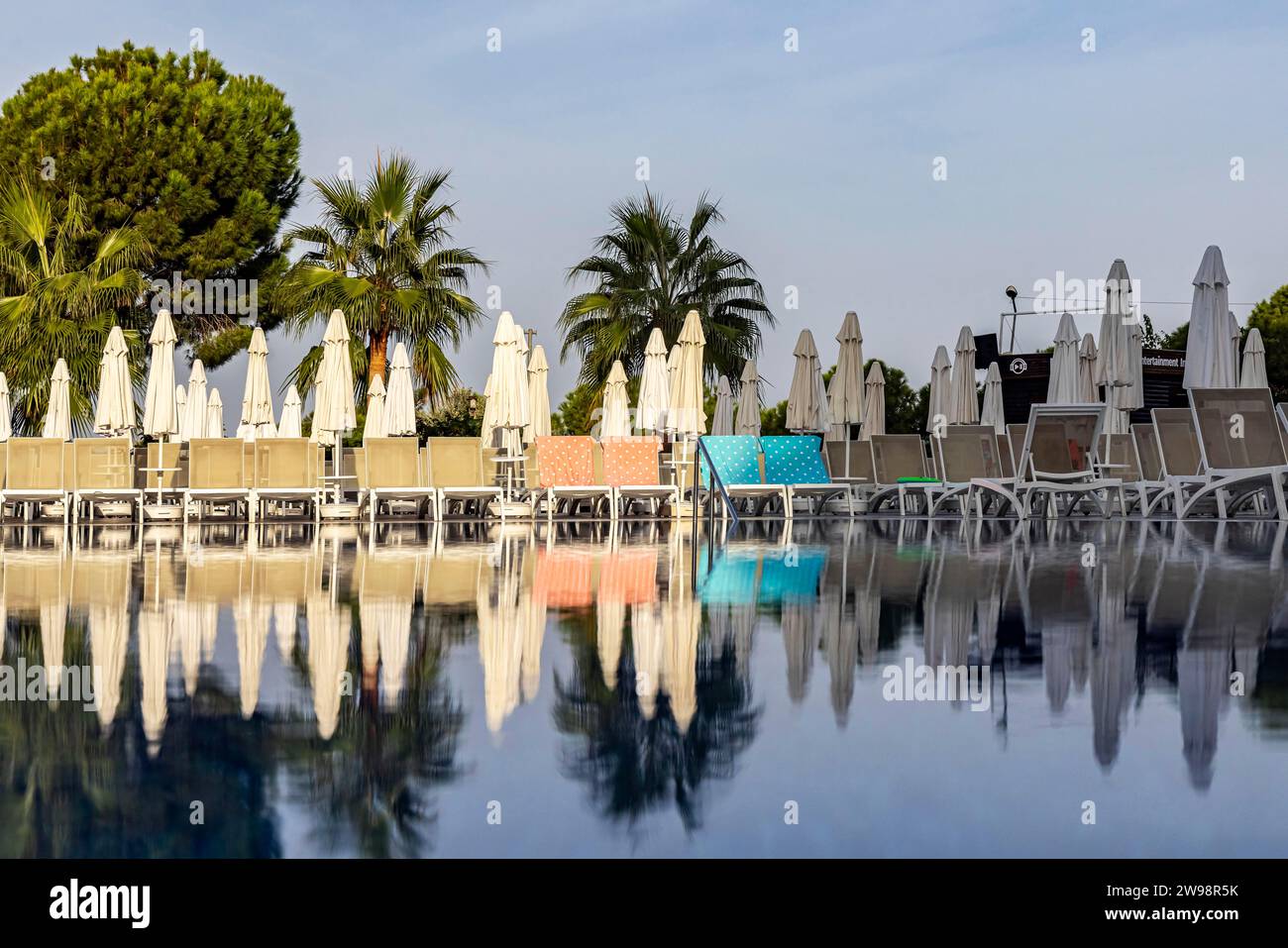 Reserved deckchairs, deserted hotel complex with swimming pool, towels lying on the deckchairs early in the morning, Kusadasi, Kusadasi, Aydin Stock Photo