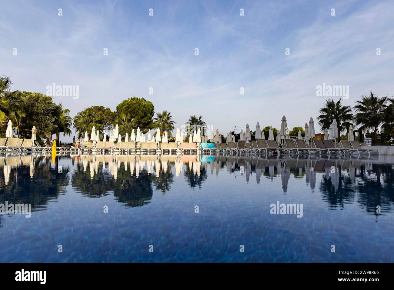 Reserved deckchairs, deserted hotel complex with swimming pool, towels lying on the deckchairs early in the morning, Kusadasi, Kusadasi, Aydin Stock Photo
