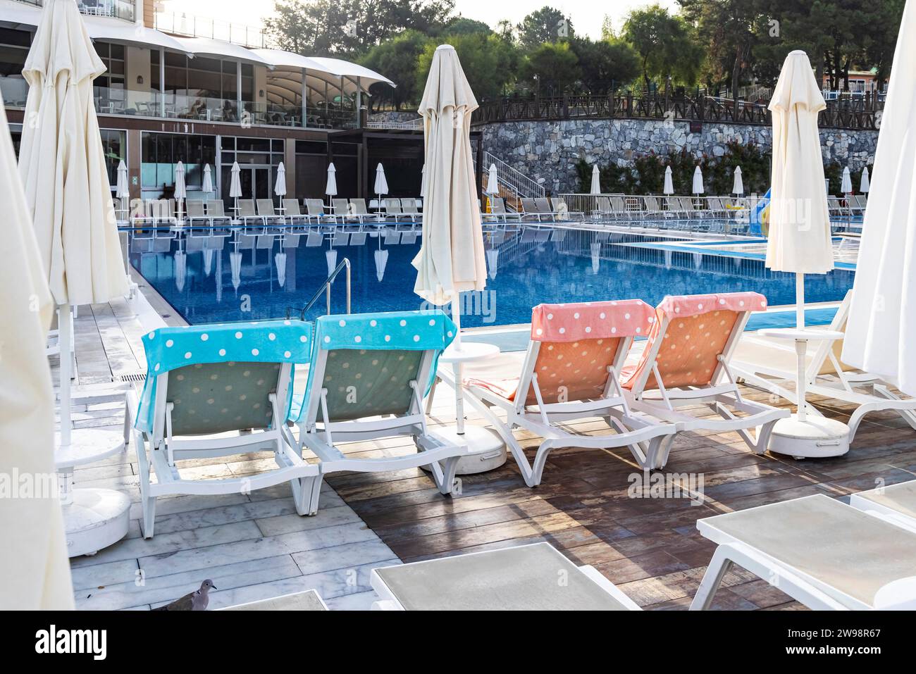 Reserved deckchairs, deserted hotel complex with swimming pool, towels lying on the deckchairs early in the morning, Kusadasi, Kusadasi, Aydin Stock Photo
