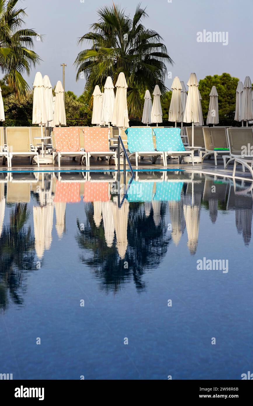 Reserved deckchairs, deserted hotel complex with swimming pool, towels lying on the deckchairs early in the morning, Kusadasi, Kusadasi, Aydin Stock Photo