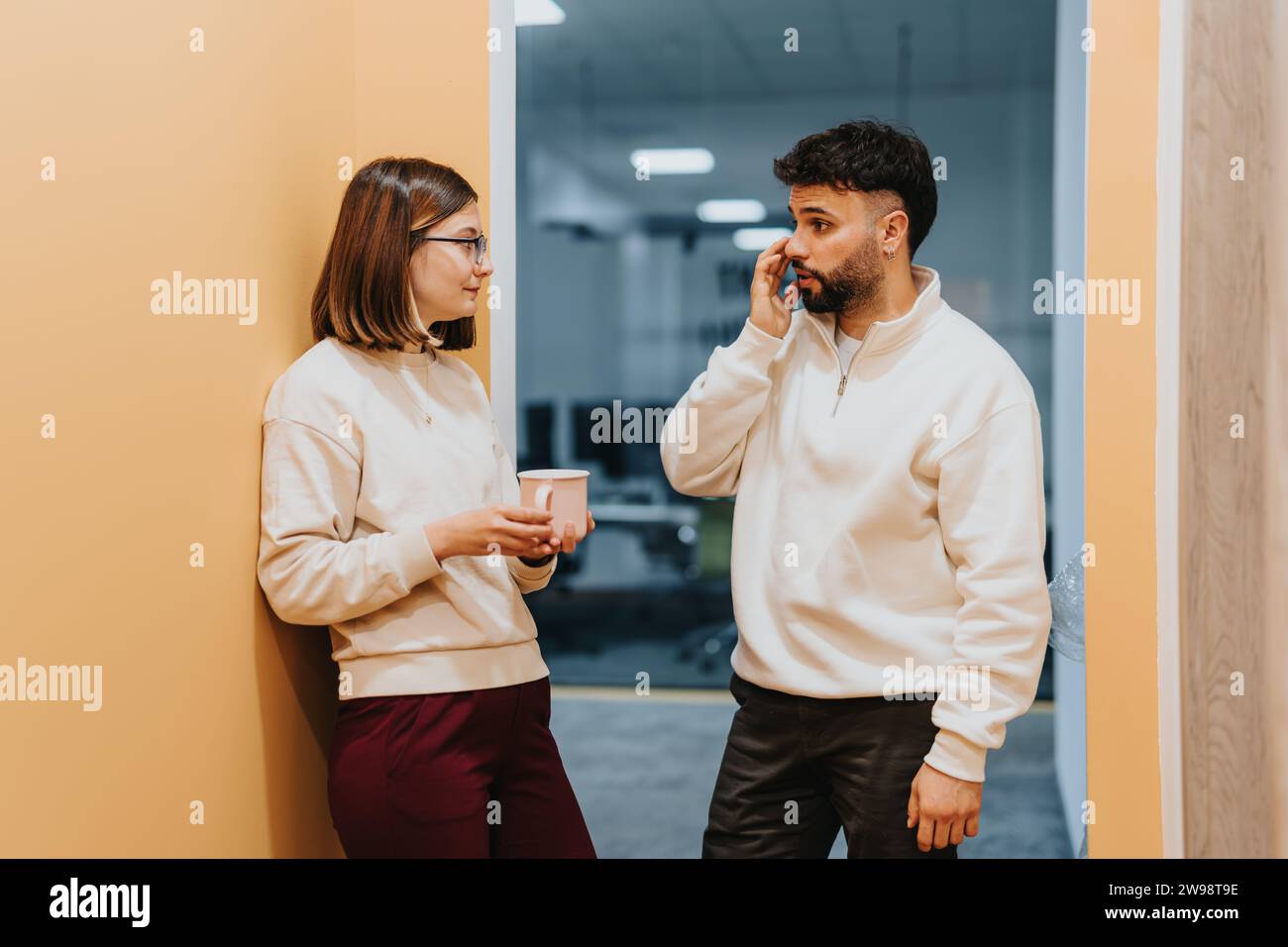 Male and female colleagues collaborating on business growth strategies in office. Stock Photo